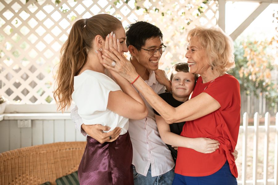 Three generations of a family embracing outdoors